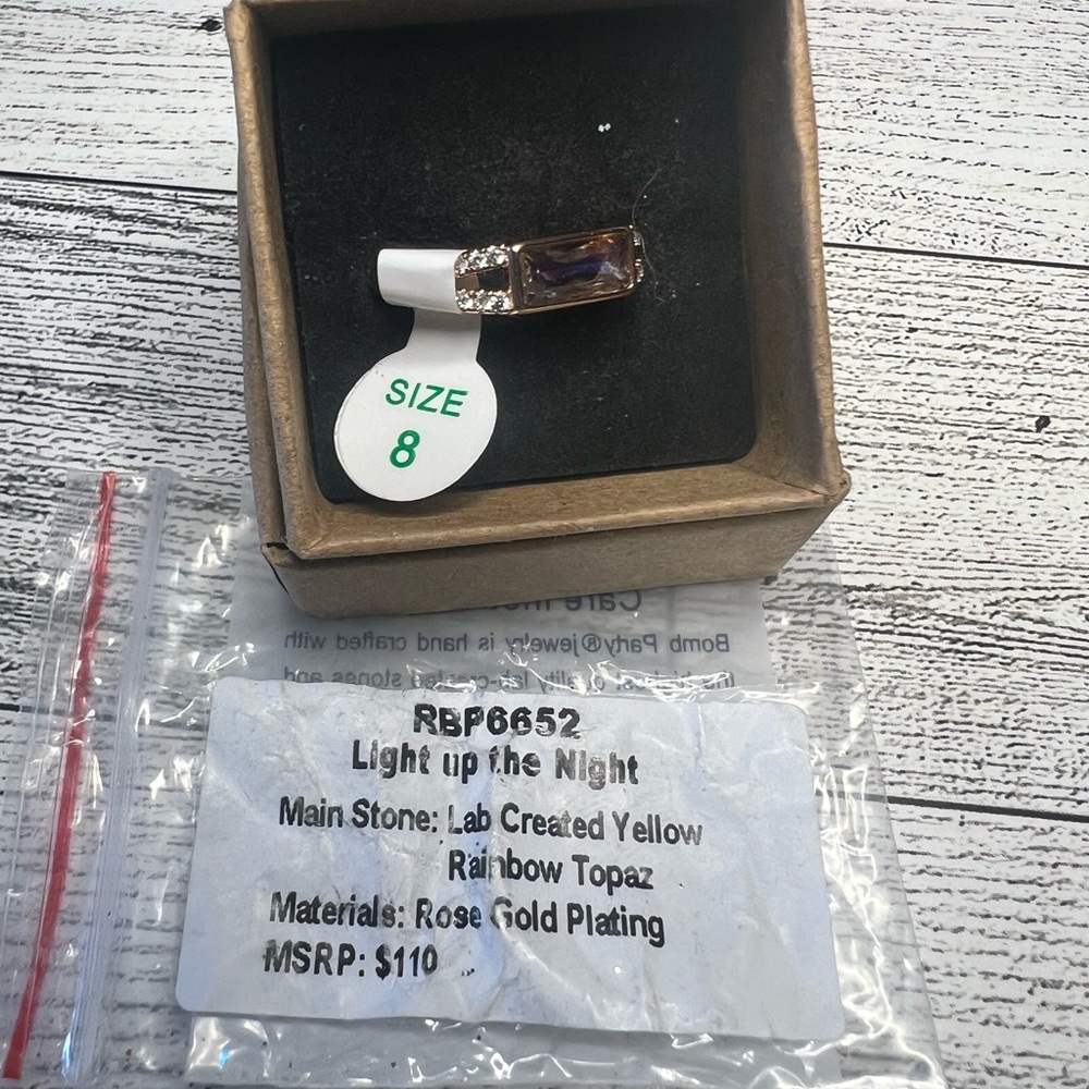 Yellow rainbow topaz on rose gold ring